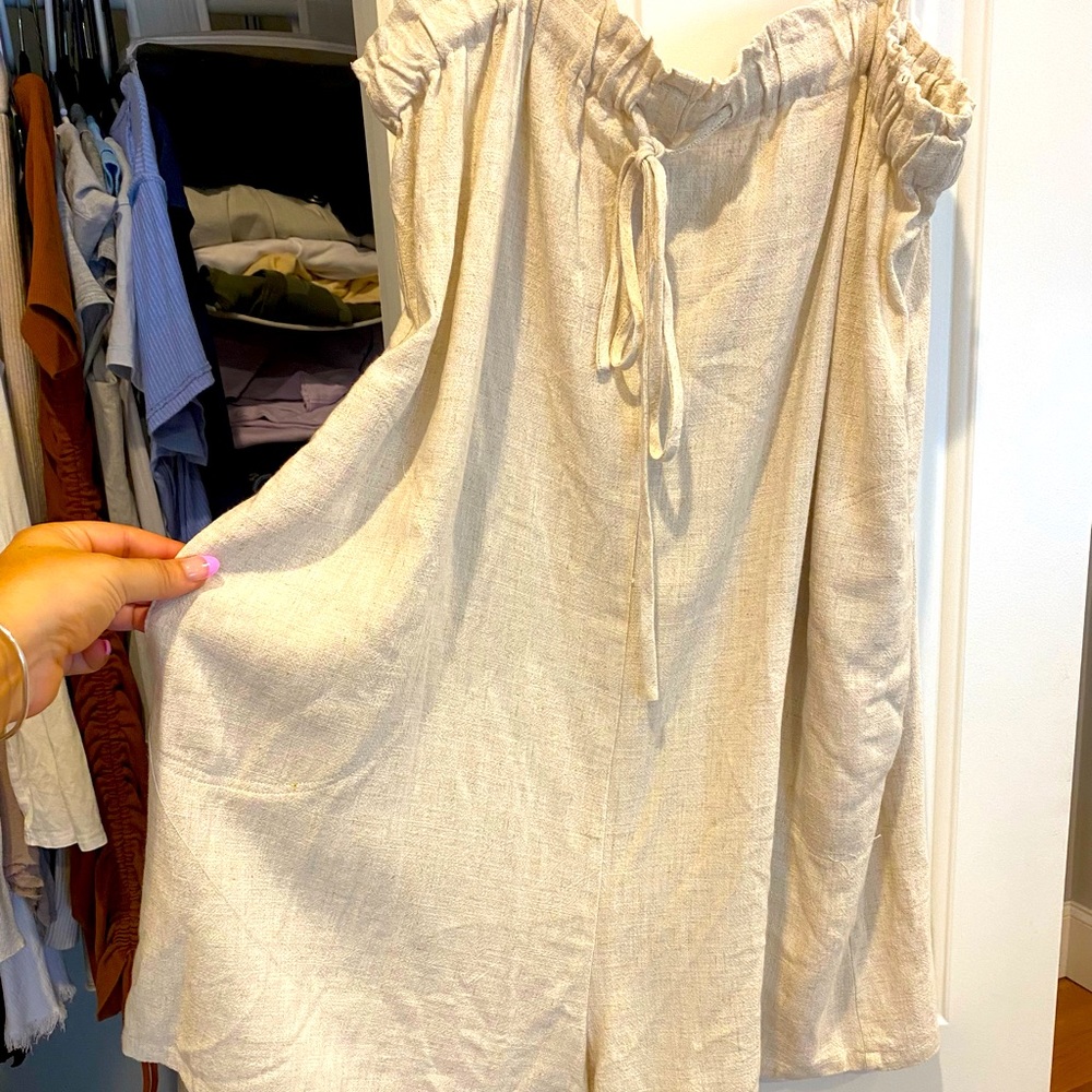 Tan romper with adjustable straps and pockets